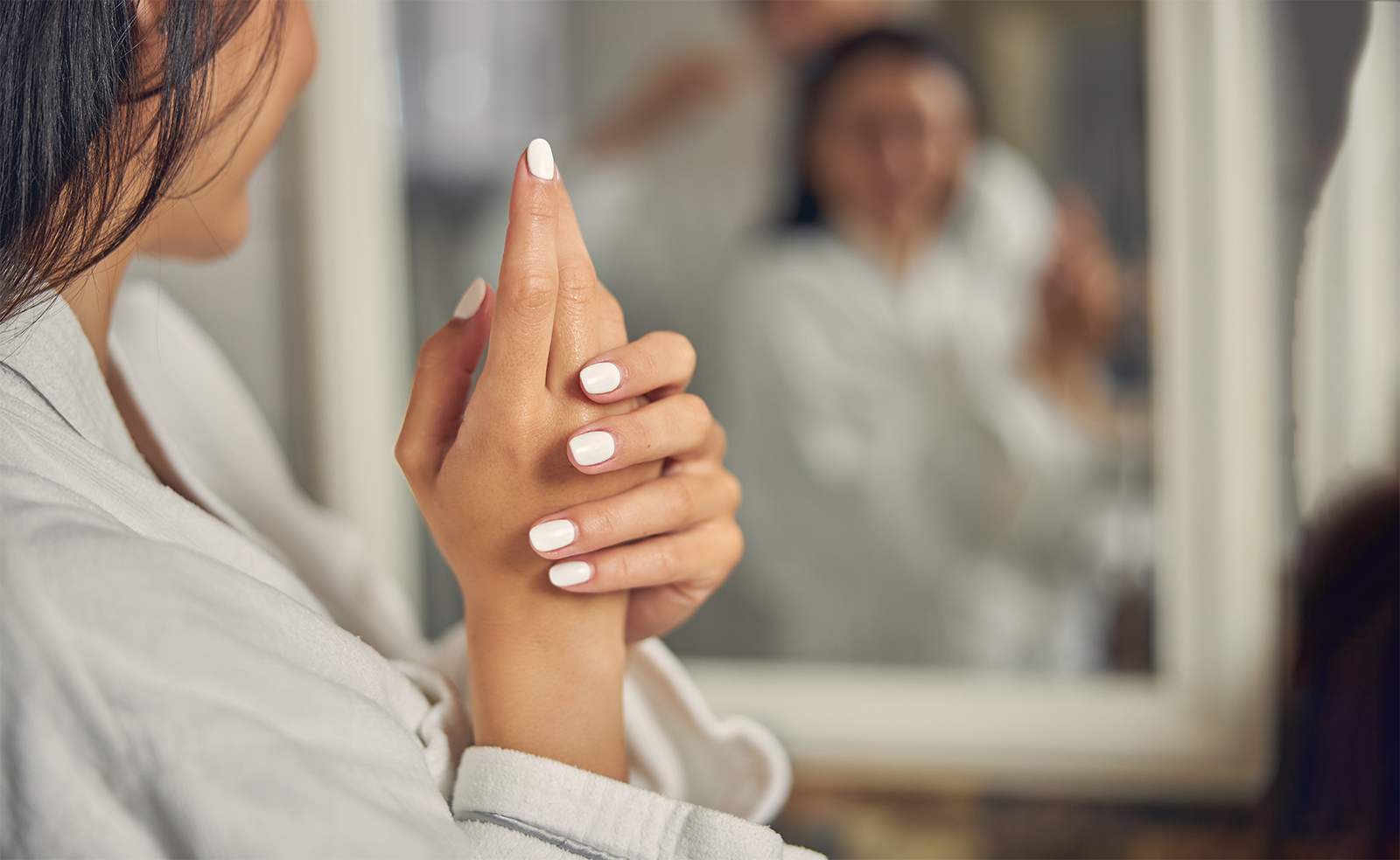 beautiful hand of woman with white manicure